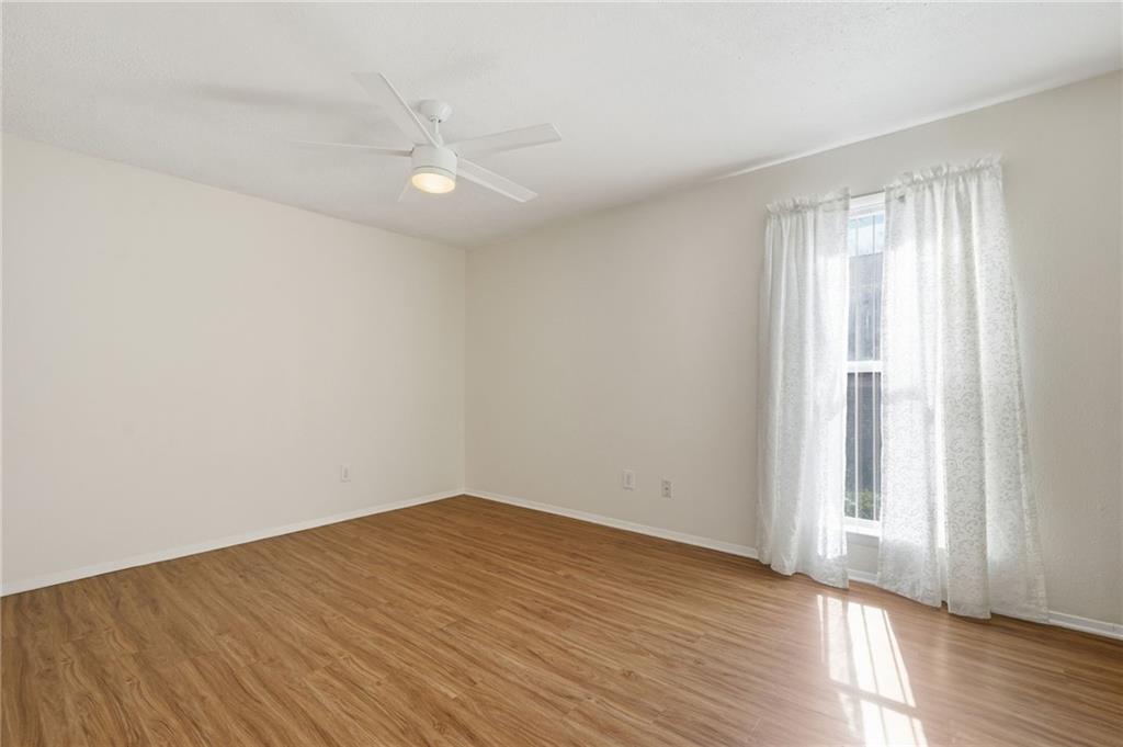 3301 Henderson Mill Road, Unit J1 Atlanta, GA 30341 - Photo 15 of 38 an empty room with wooden floor and windows