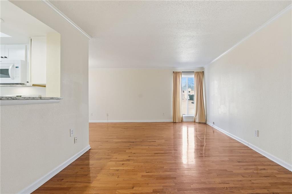 3301 Henderson Mill Road, Unit J1 Atlanta, GA 30341 - Photo 5 of 38 a view of an empty room with window and wooden floor