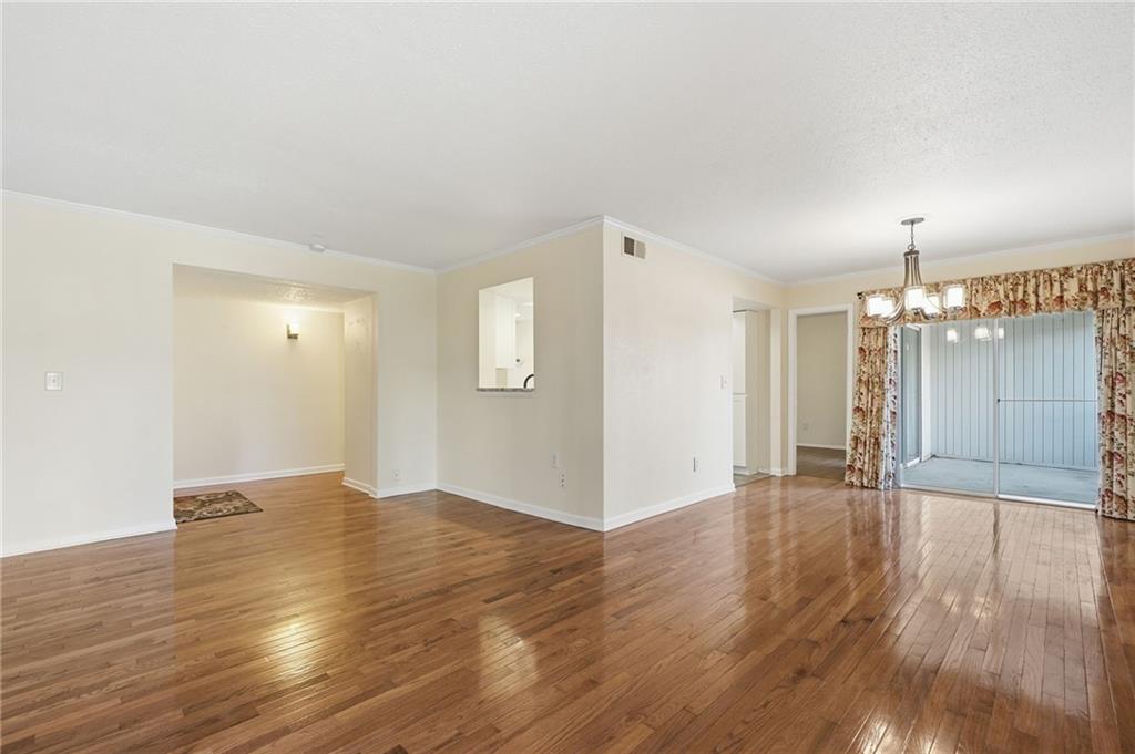 3301 Henderson Mill Road, Unit J1 Atlanta, GA 30341 - Photo 7 of 38 an empty room with wooden floor and windows