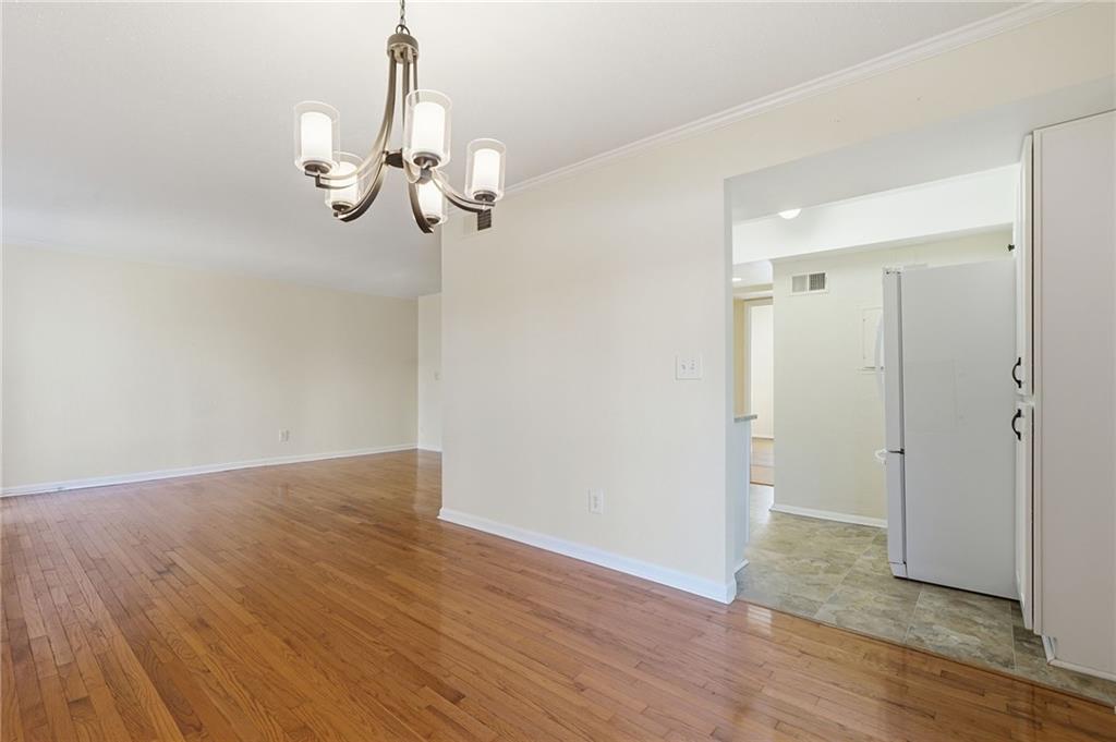 3301 Henderson Mill Road, Unit J1 Atlanta, GA 30341 - Photo 8 of 38 a view of a room with wooden floor and chandelier