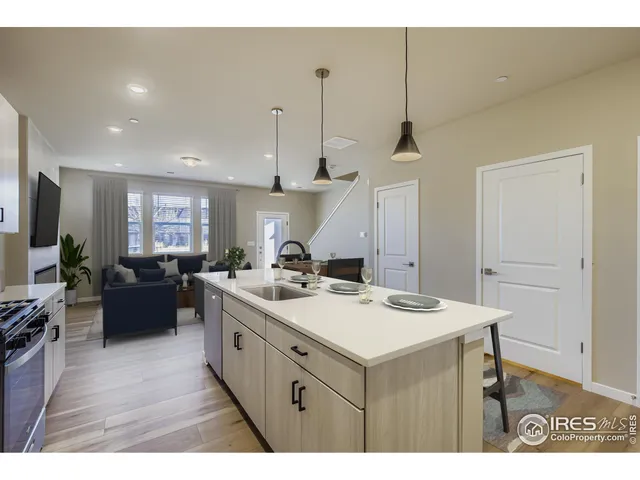 a kitchen with a stove a sink a refrigerator and a refrigerator