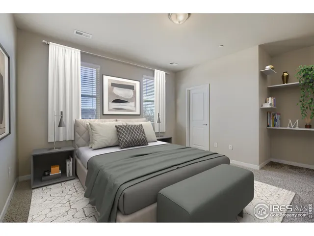 a bedroom with a bed and a night stand