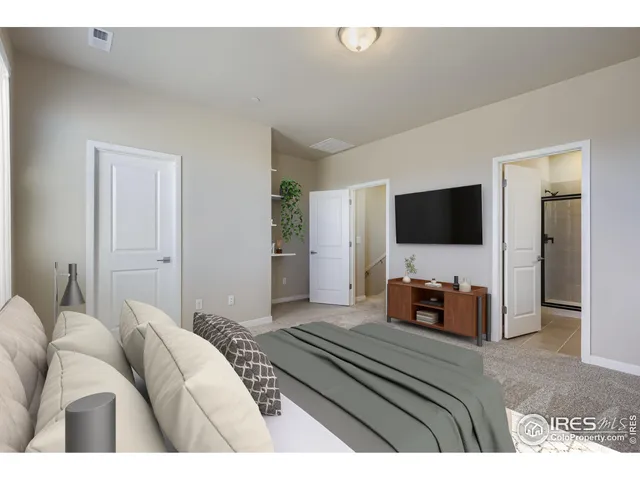 a bedroom with a bed and a flat screen television