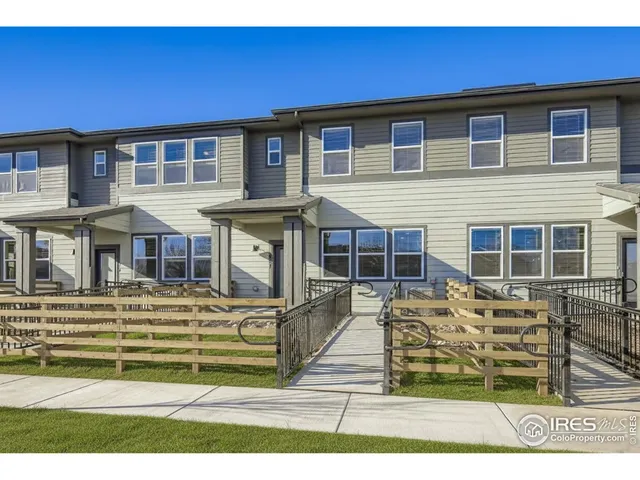 a front view of residential houses with outdoor space