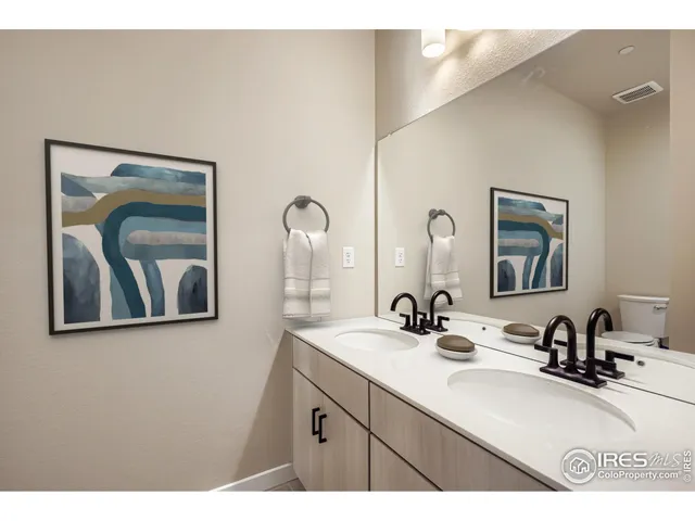 a bathroom with a double vanity sink and a mirror