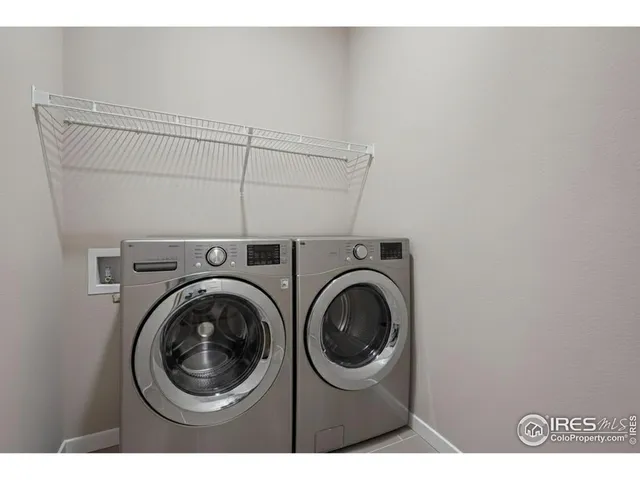 a view of a hallway with washer and dryer