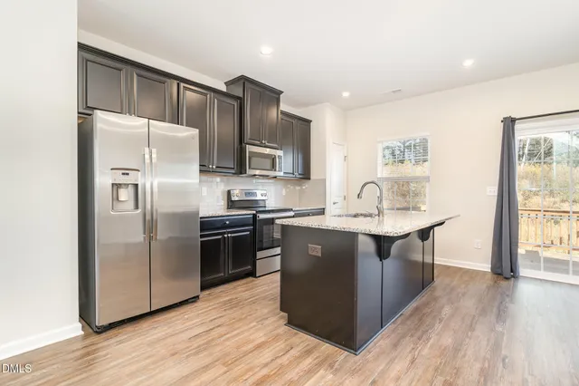 a view of a hallway with wooden floor and entryway
