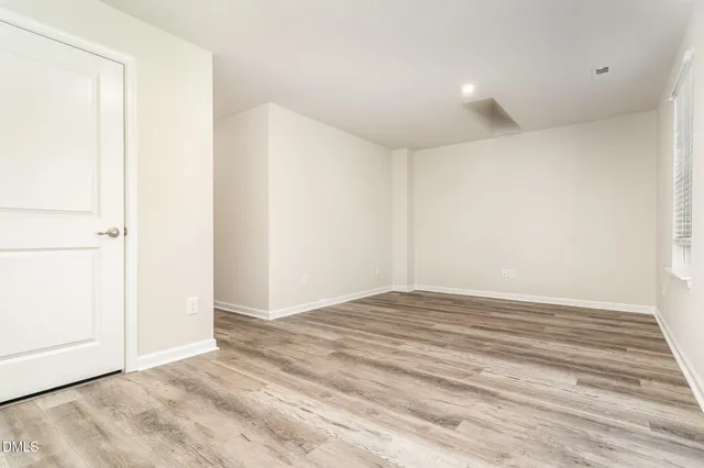 an empty room with closet area