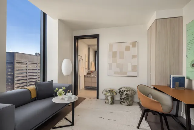 a bathroom with a large mirror and toilet