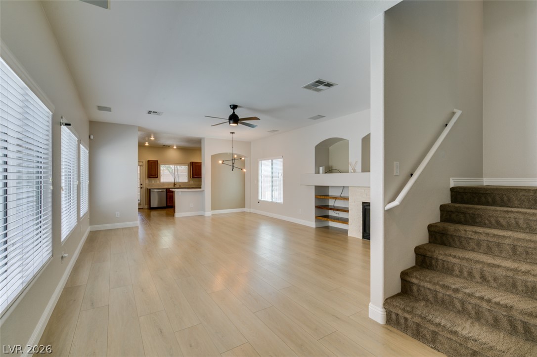 8909 Houston Ridge Avenue Las Vegas, NV 89178 - Photo 45 of 45 An open floorplan with light wood flooring provides seamless flow between the living area and kitchen.