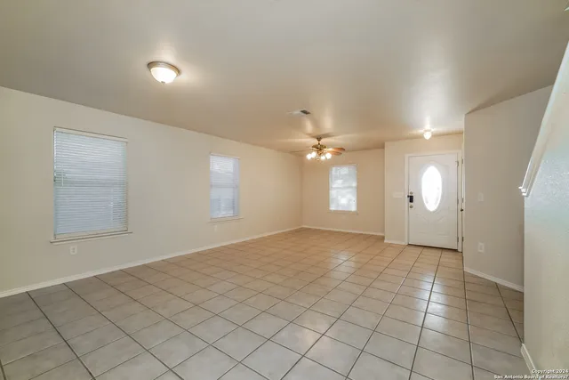 an empty room with windows and entrance