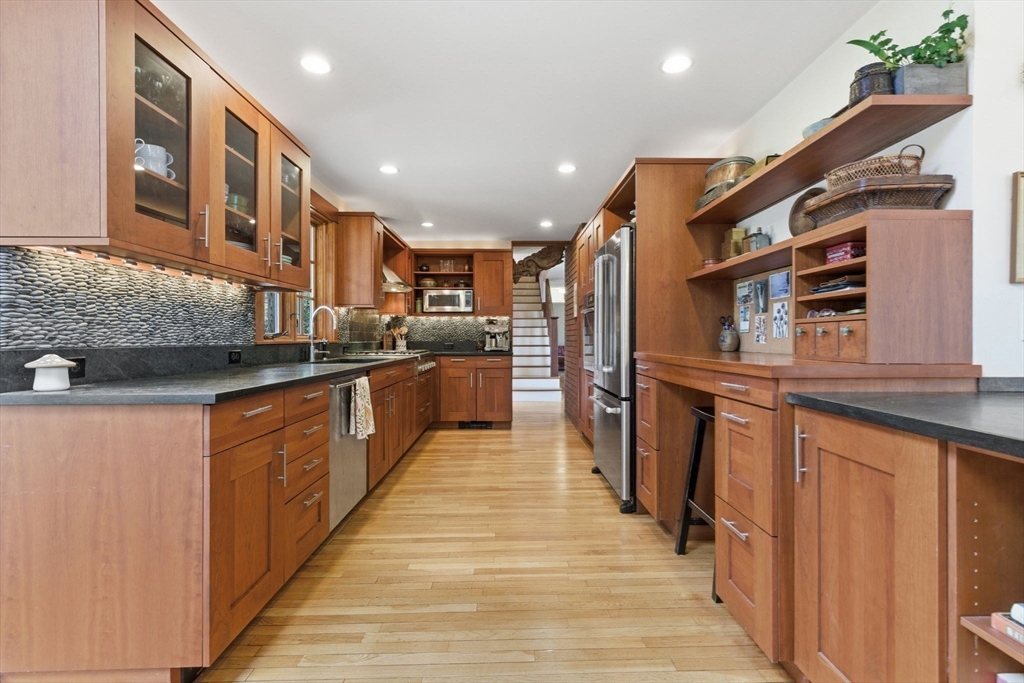30 Volunteer Way Lexington, MA 02420 - Photo 5 of 41 a kitchen with stainless steel appliances granite countertop a refrigerator a stove and a sink