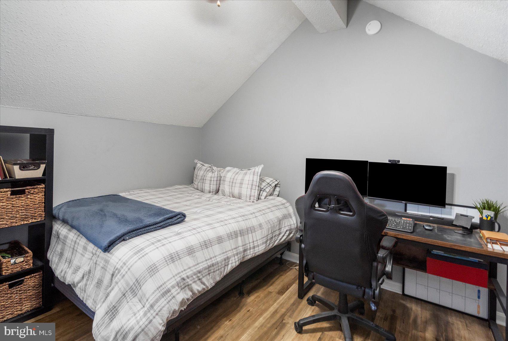 14105 William Street, Unit 15C Laurel, MD 20707 - Photo 11 of 24 a bedroom with a bed and a computer on a desk next to a window