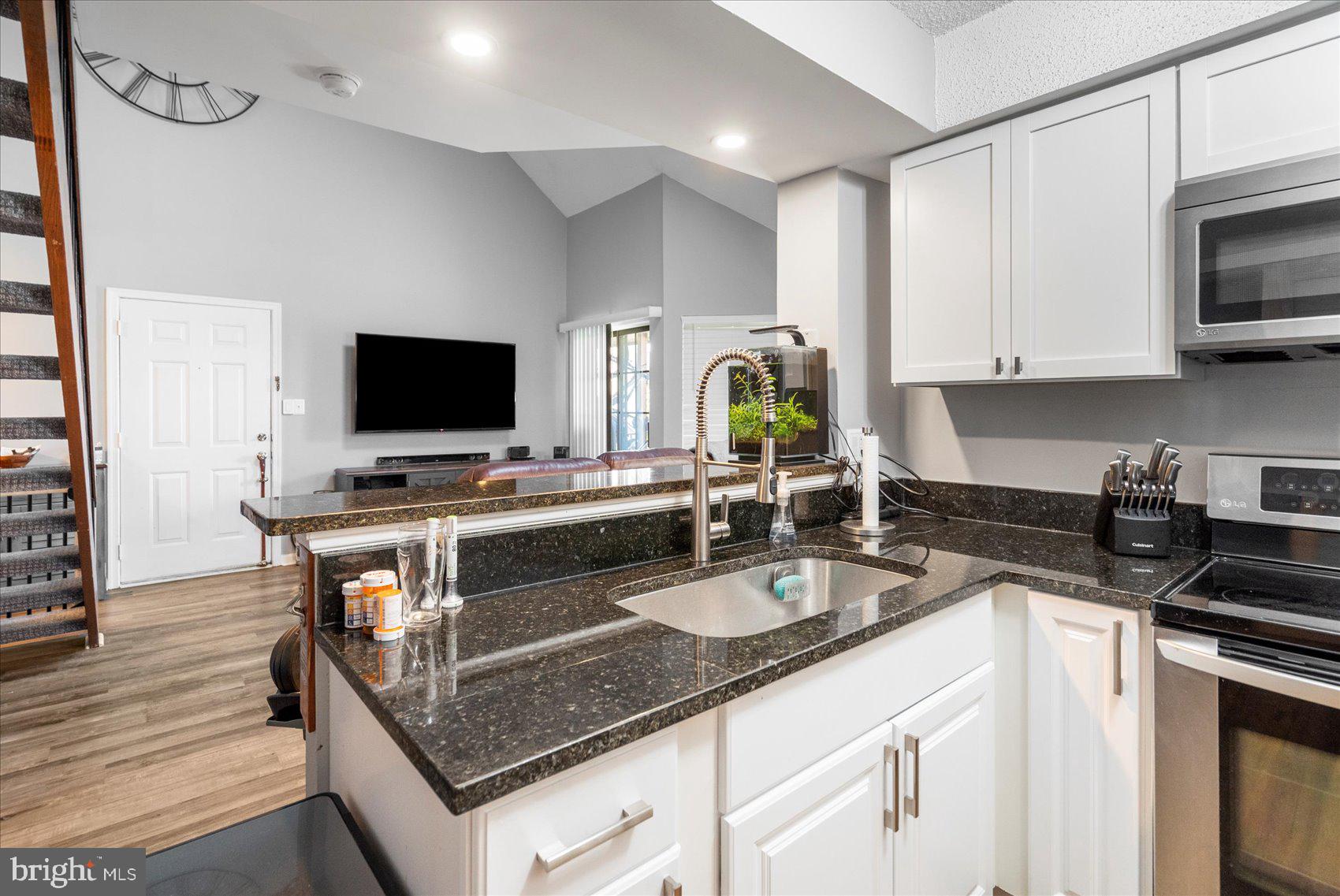 14105 William Street, Unit 15C Laurel, MD 20707 - Photo 17 of 24 a kitchen with a sink stove and microwave