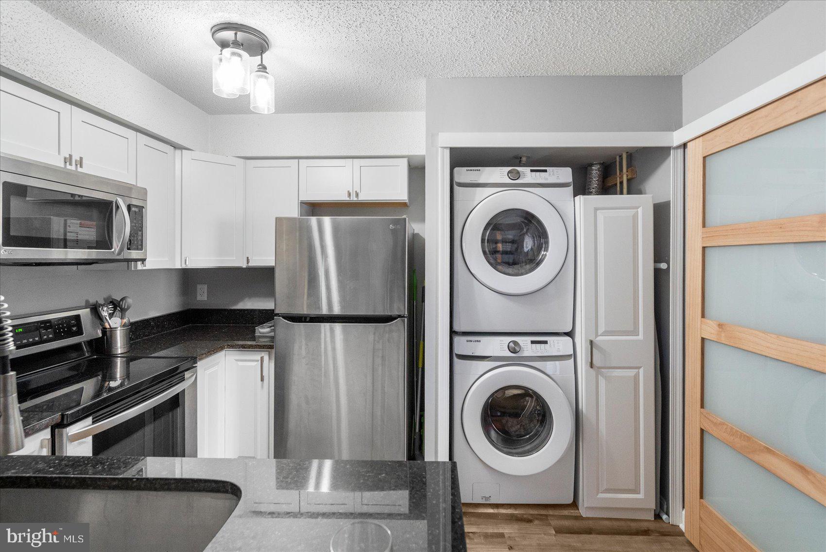 14105 William Street, Unit 15C Laurel, MD 20707 - Photo 19 of 24 a kitchen with a refrigerator and a stove top oven