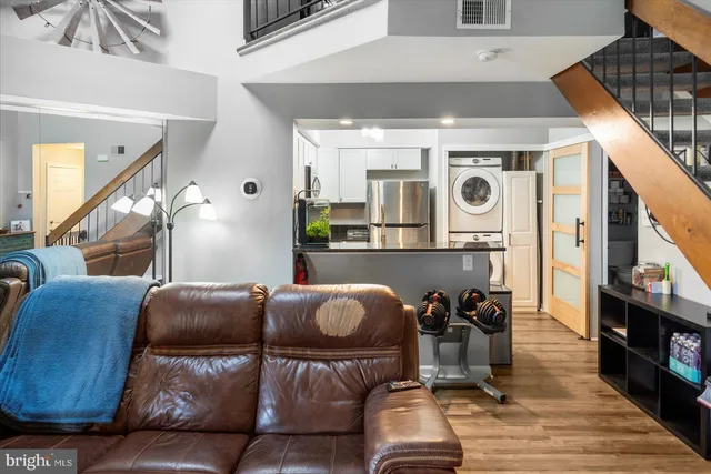 a living room with furniture and a clock