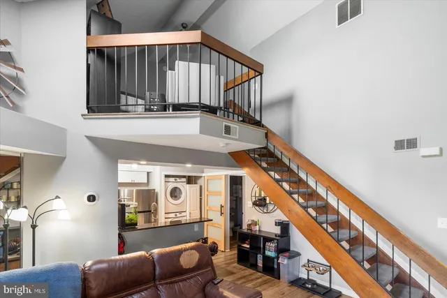 a view of entryway and hall with wooden floor