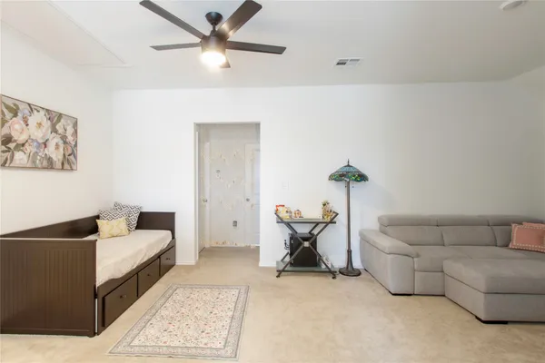 a living room with furniture and white walls
