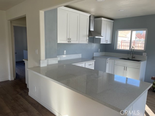 a kitchen with stainless steel appliances granite countertop a sink a stove and a granite counter tops with a large window