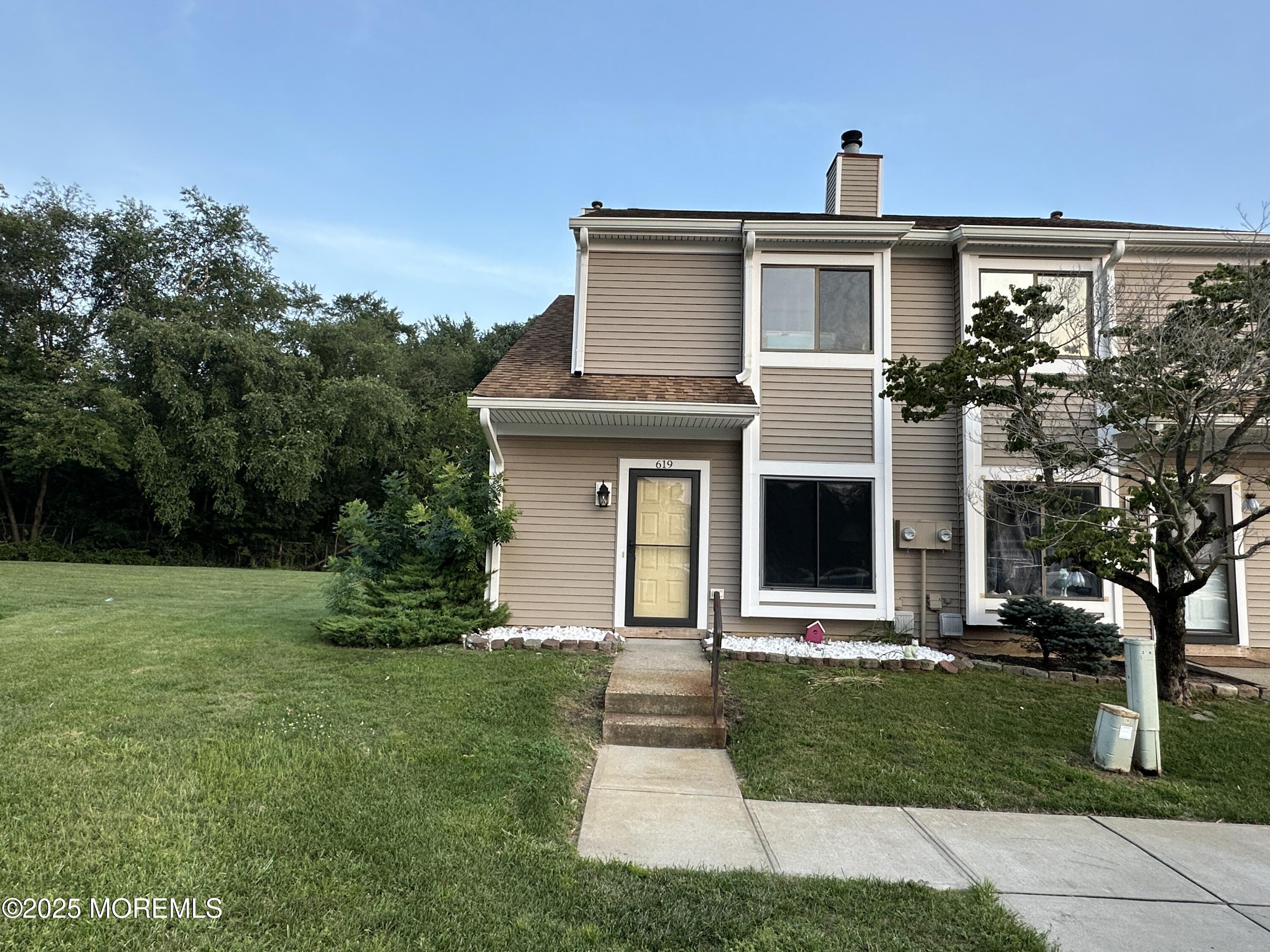 619 Sandra Place Brick, NJ 08724 - Photo 1 of 19 a front view of a house with a yard and trees