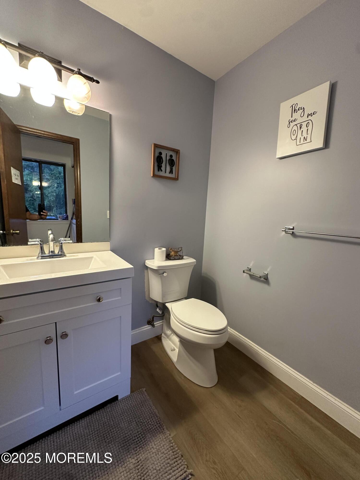 619 Sandra Place Brick, NJ 08724 - Photo 15 of 19 a bathroom with a toilet sink vanity and mirror