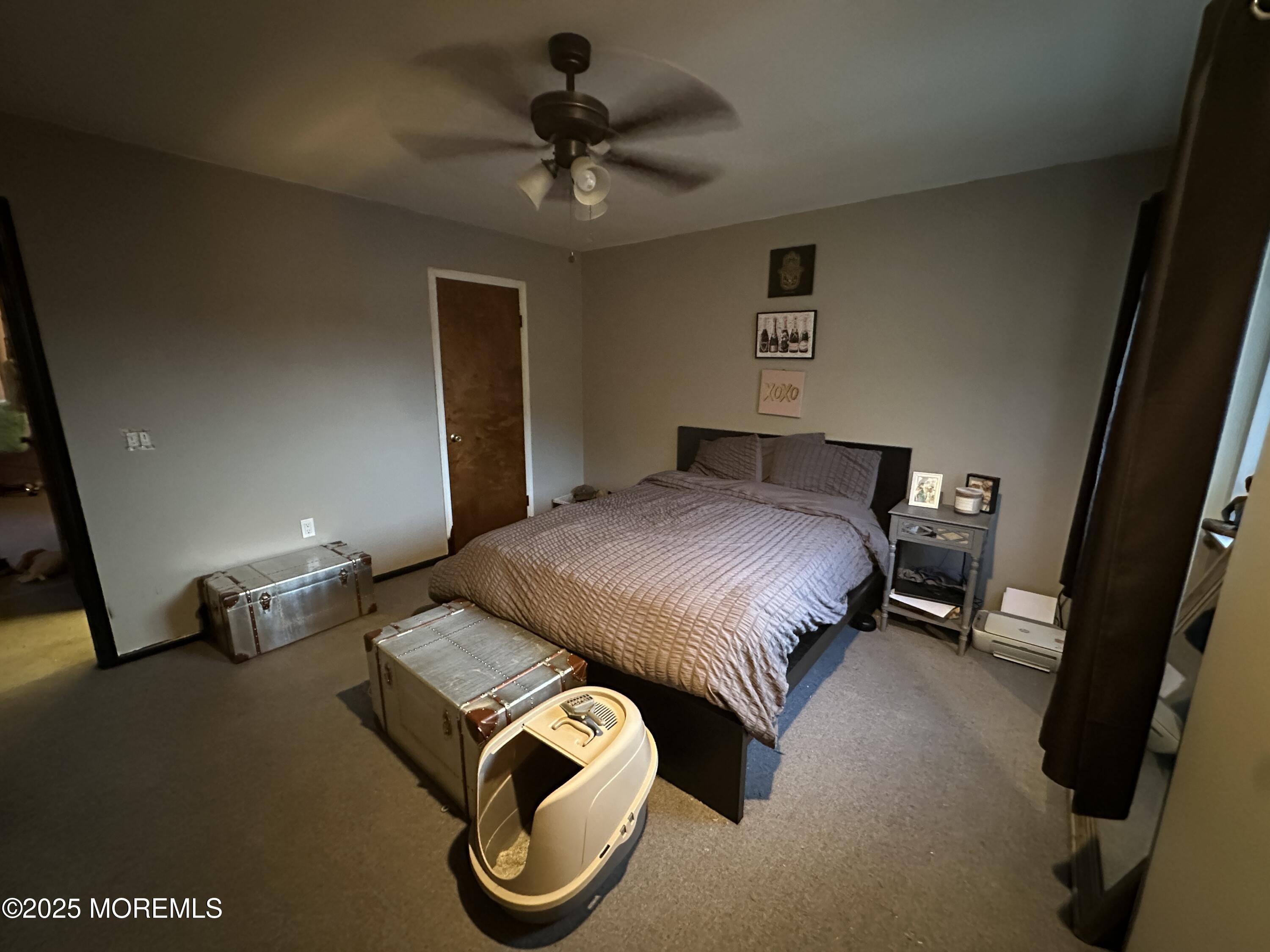 619 Sandra Place Brick, NJ 08724 - Photo 17 of 19 a bedroom with a bed and a chandelier