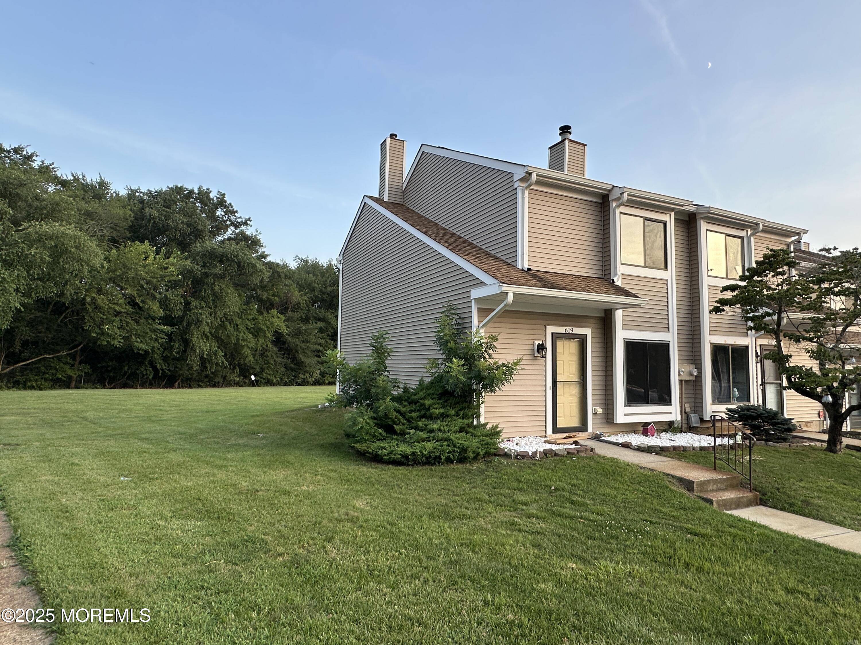 619 Sandra Place Brick, NJ 08724 - Photo 2 of 19 a front view of a house with a yard