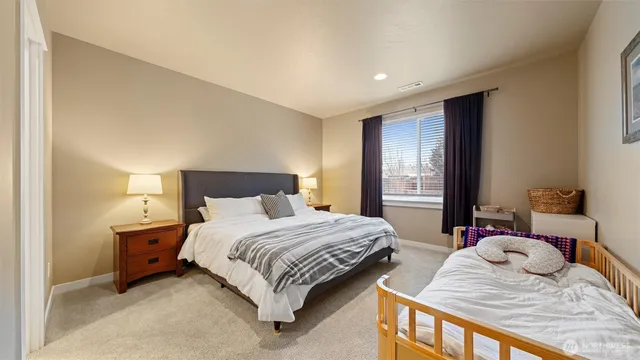 a bedroom with a bed and a lamp on table