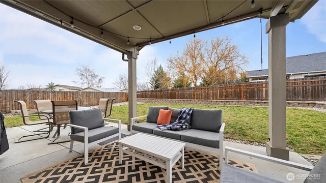 a view of a backyard with table and chairs with a yard