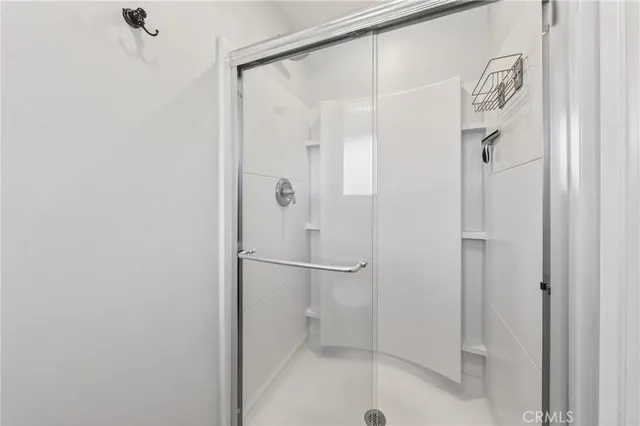 a bathroom with a glass shower door