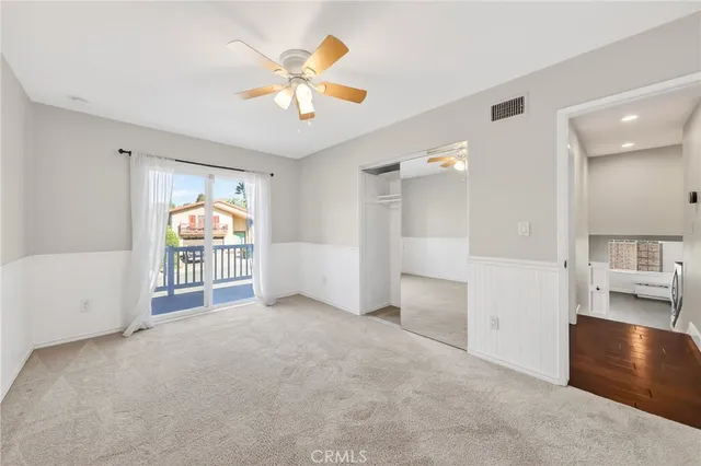 a view of a livingroom with a furniture hardwood floor and a ceiling fan