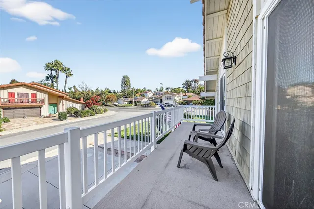 a view of a balcony with wooden benches