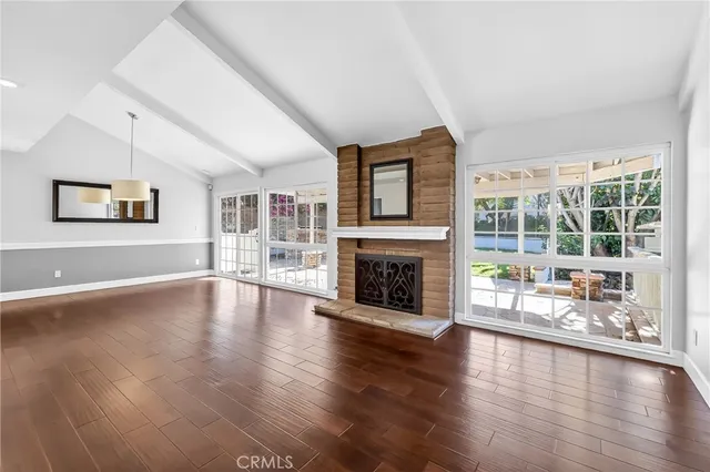 a view of a livingroom with wooden floor a fireplace