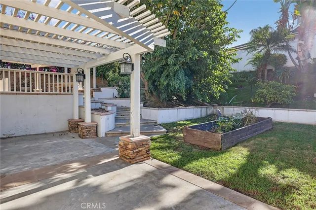 a view of a chair and tables in the backyard