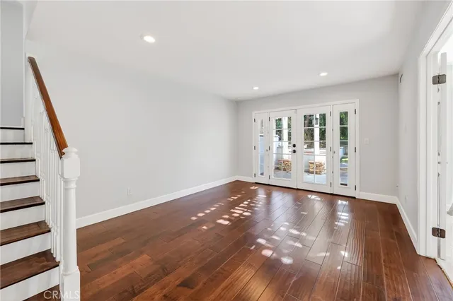 a view of a room with wooden floor and white walls