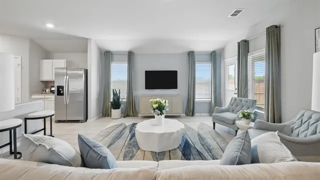 a living room with furniture and a large window