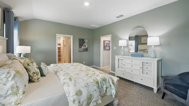 a bedroom with a bed and a table in it