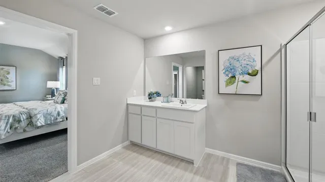a spacious bathroom with a shower a sink and a mirror