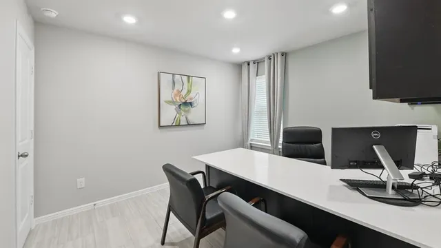 a view of kitchen with granite countertop window and wooden floor