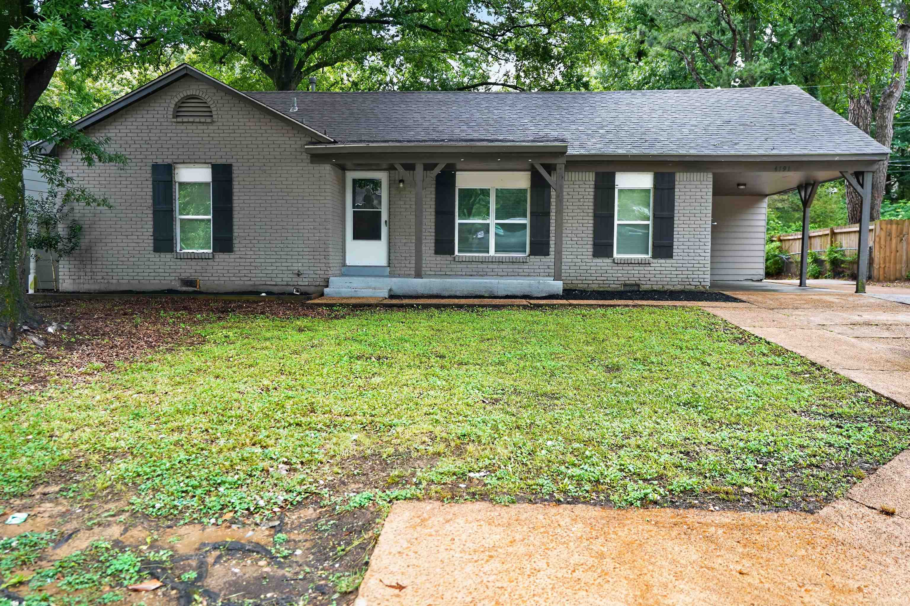 4191 Yale Road Memphis, TN 38128 - Photo 2 of 22 Grey brick exterior with a carport and front porch entry