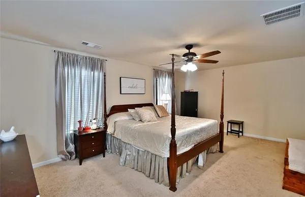 a bed room with a bed and a chandelier