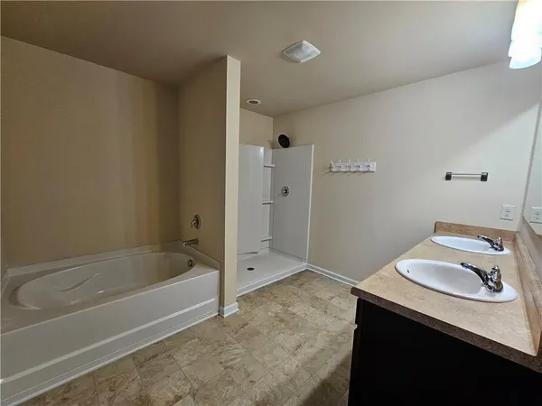 a bathroom with a bathtub sink vanity and toilet