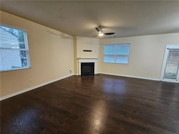 a view of kitchen with wooden floor electronic appliances and window