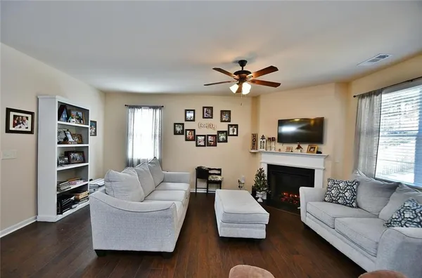 a living room with furniture flat screen tv and a fireplace
