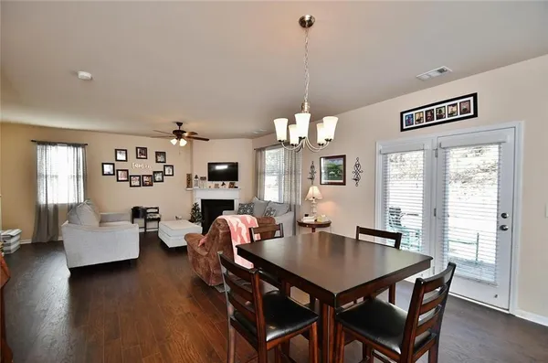 a view of a dining room with furniture wooden floor and chandelier