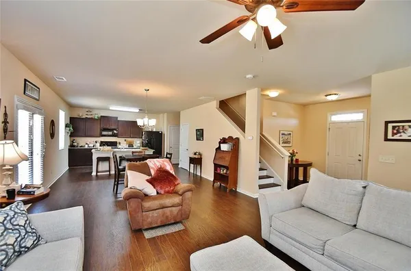 a living room with furniture and wooden floor