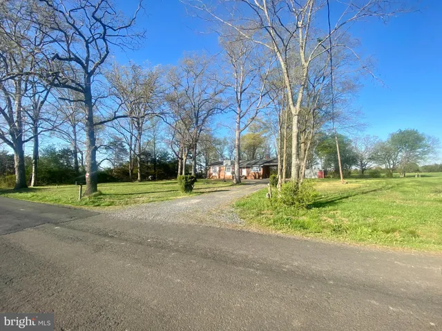 a view of a room with wooden floor and window