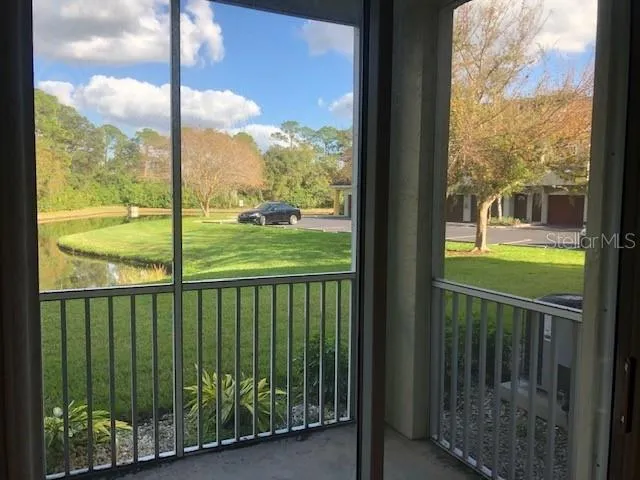 a view of a balcony with floor to ceiling window wooden floor and fence