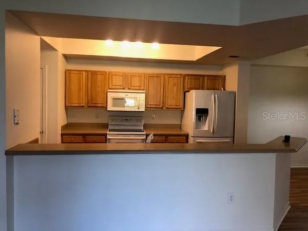 a kitchen with stainless steel appliances a sink and a microwave