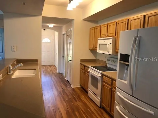 a kitchen with a refrigerator sink and stove